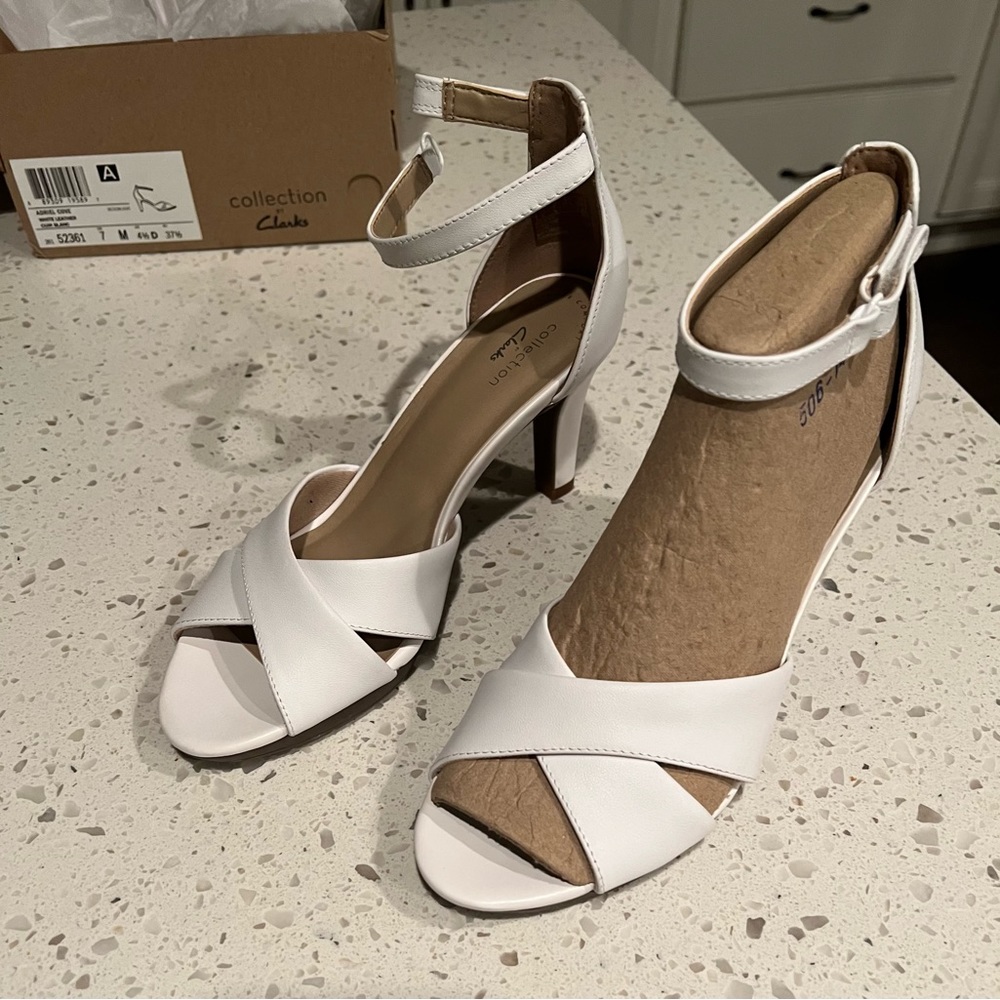 Clark’s women white strap heel.  NWT, never worn, in original shoe box.  Size 7.